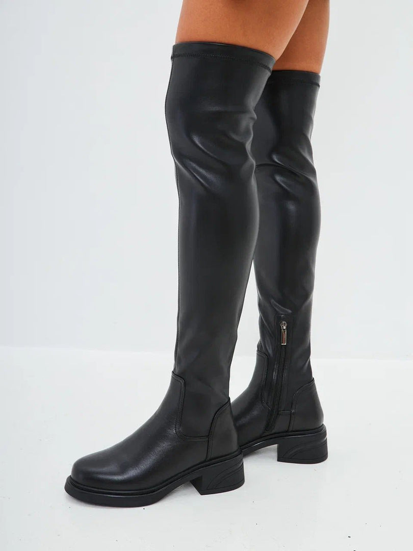 A pair of stylish over-the-knee suede boots, the ultimate fashion statement in women's footwear.