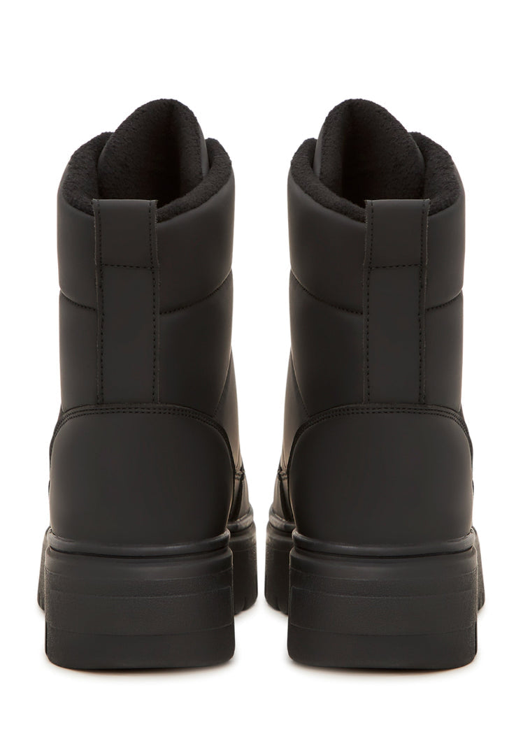 A stylish pair of elegant black snow boots, perfect for winter, with a fashionable and sleek design.