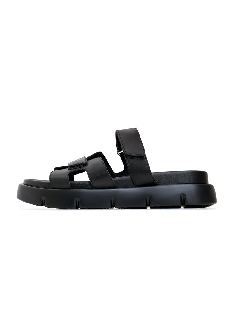 A stylish pair of black Kati platform mules on a white background