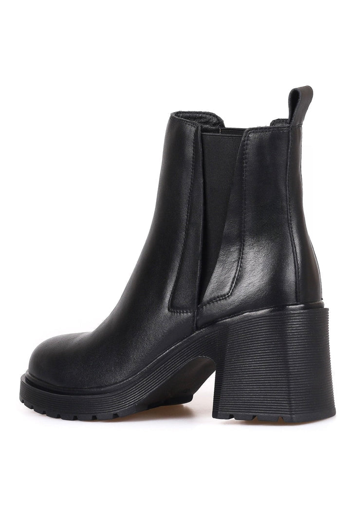 A stylish woman wearing trendy ankle boots - a blend of casual and classic design, perfect for women looking for fashionable footwear.