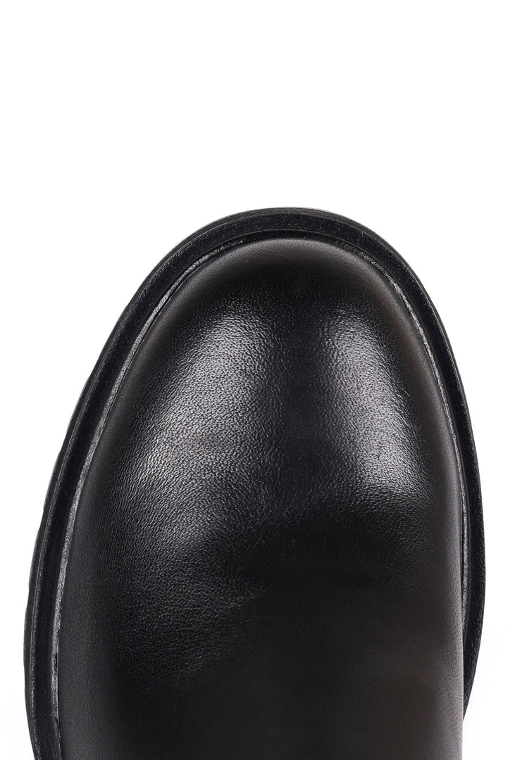 A stylish woman wearing trendy casual ankle boots, perfect for a casual yet classic look.