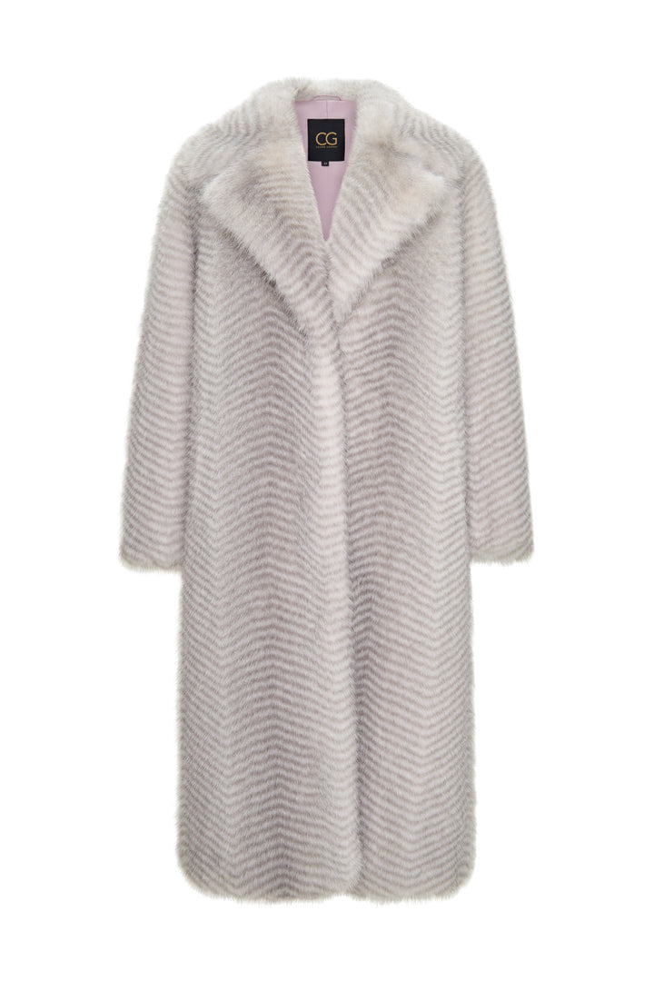 A glamorous woman wearing a luxurious white faux fur coat by Natalie, a high-end designer.