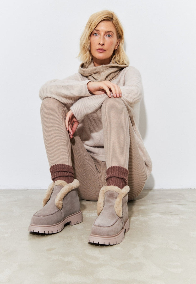 A pair of stylish women's suede ankle winter boots, perfect for cold weather days.