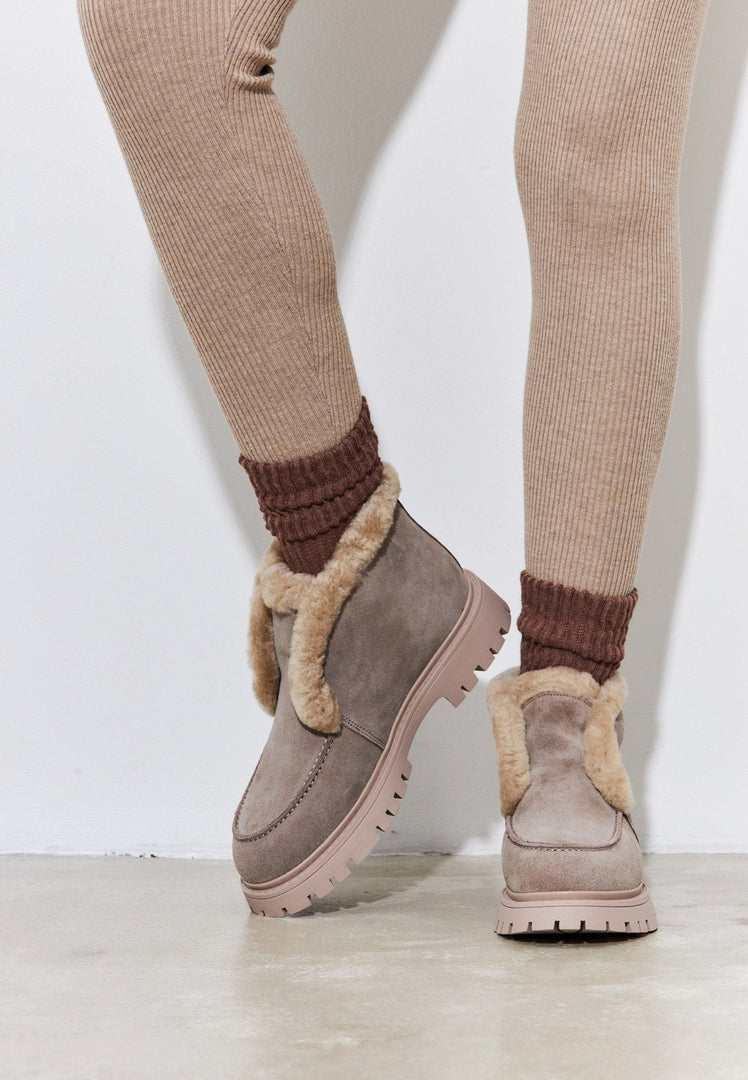 A fashionable pair of women's suede ankle winter boots, perfect for staying warm and stylish during the cold season.