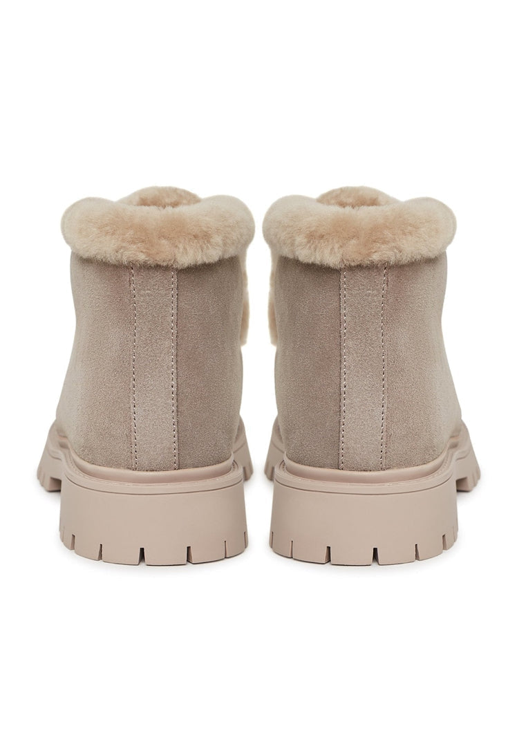 A stylish pair of women's suede ankle winter boots, perfect for staying warm and fashionable in the cold weather.