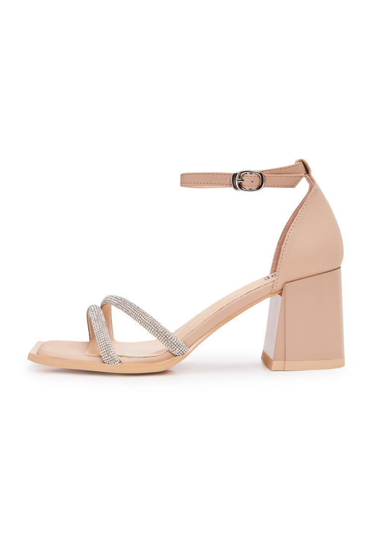 A stylish pair of beige block heeled sandals with an open toe design, perfect for adding a touch of elegance to any outfit.