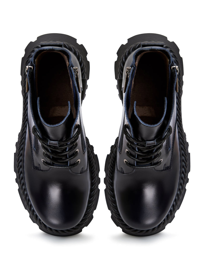 A pair of stylish lace-up ankle boots in blue, giving off a fashionable and trendy vibe.