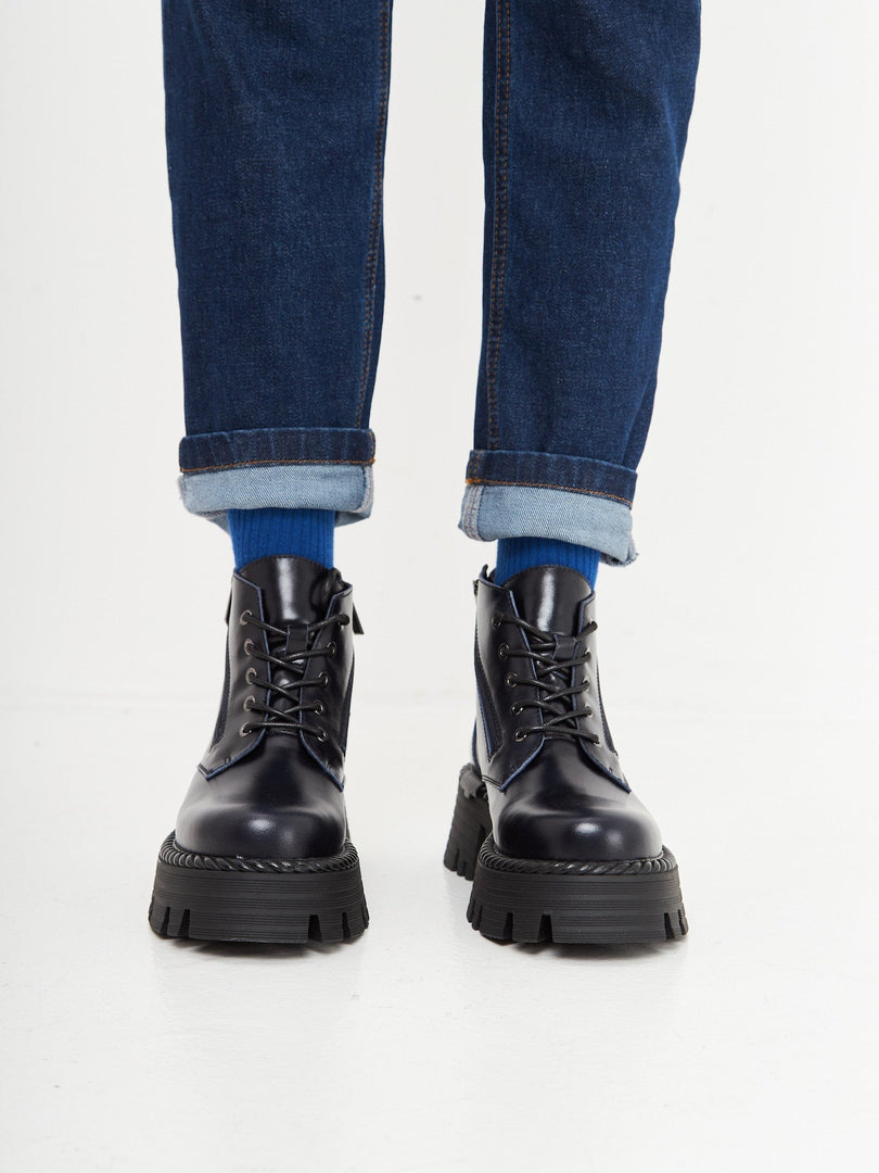A pair of stylish lace-up ankle boots in a beautiful blue color, perfect for a fashionable look.