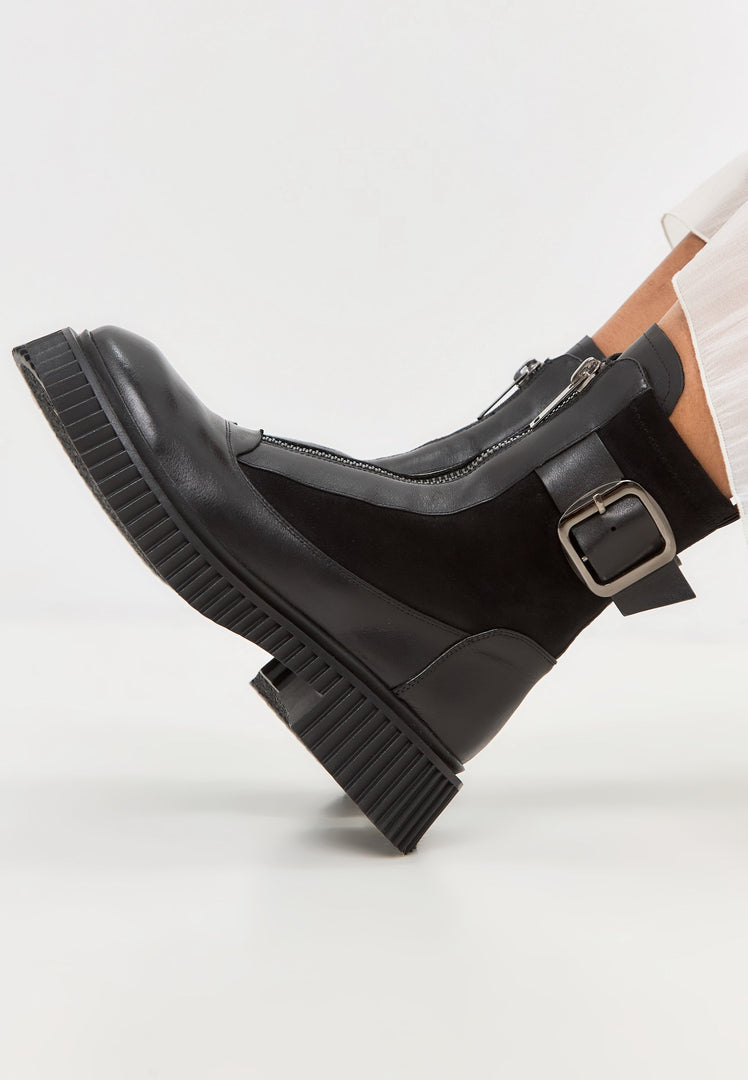 A trendy pair of black Ciara ankle boots with chunky soles, perfect for adding style to any outfit.