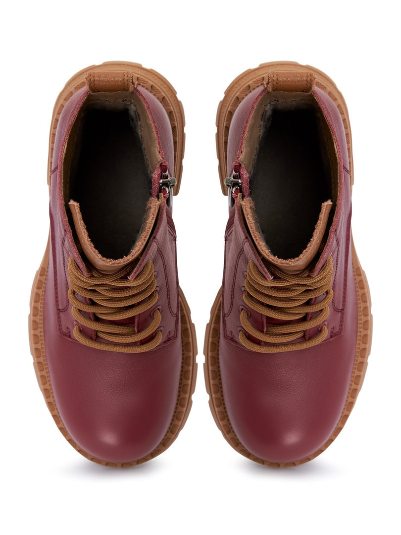 A pair of stylish women's lace-up leather ankle boots in Bordeaux color - must-have fashion footwear.