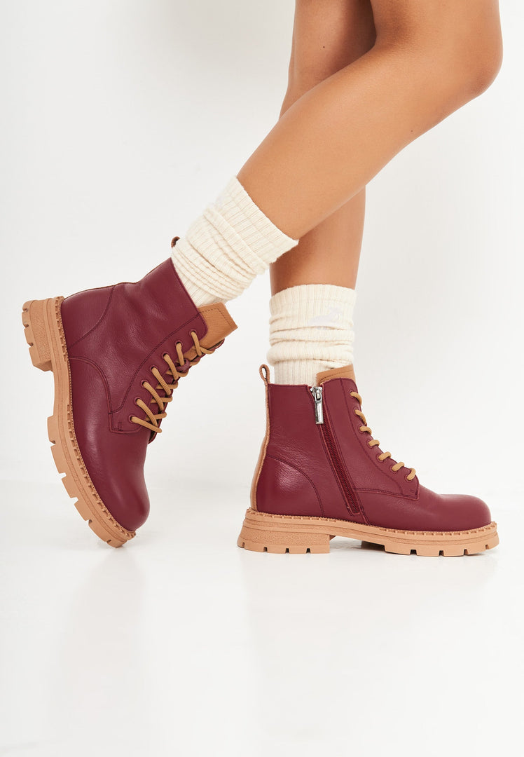 A stylish pair of women's lace-up leather ankle boots in a rich Bordeaux color, perfect for adding a touch of fashion to any outfit.