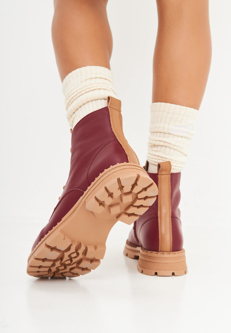 A stylish pair of women's leather ankle lace-up boots in bordeaux color, perfect for fashionable footwear lovers.