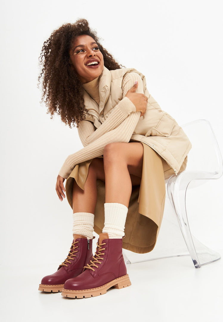 Stylish women's lace-up leather ankle boots in a trendy bordeaux color, perfect for fashion-forward footwear looks.