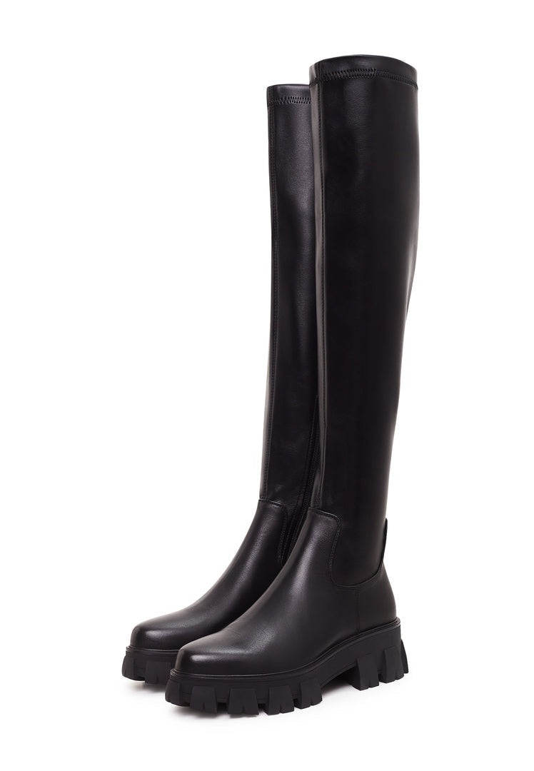 A pair of stylish knee-high Karlie fashion boots with chunky black soles - the perfect statement footwear.