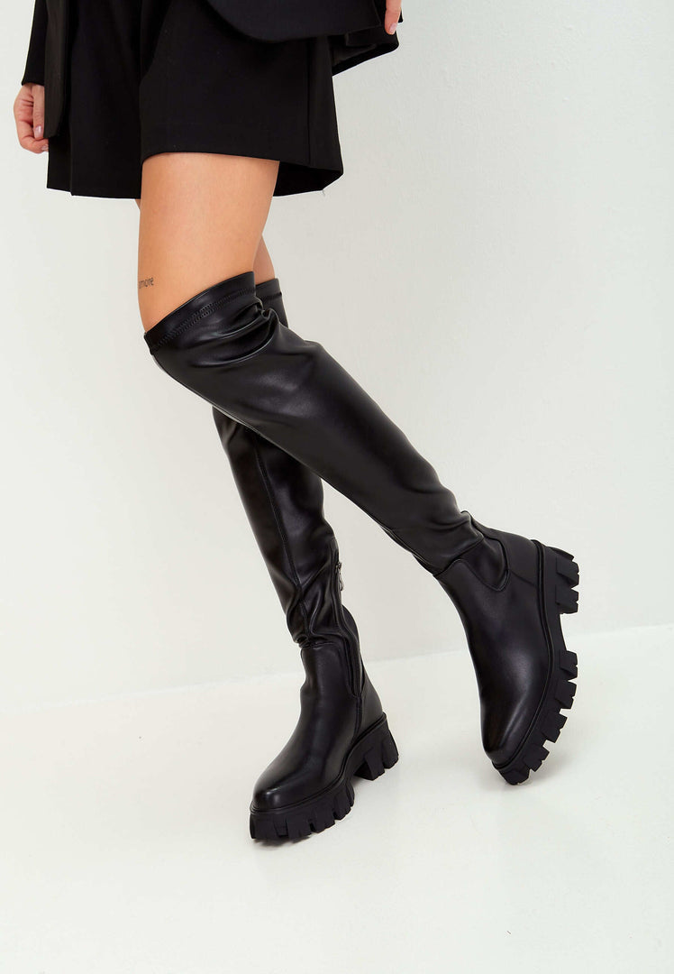 A stylish pair of knee-high chunky sole Karlie fashion black boots - the perfect choice for fashionable and trendy footwear.