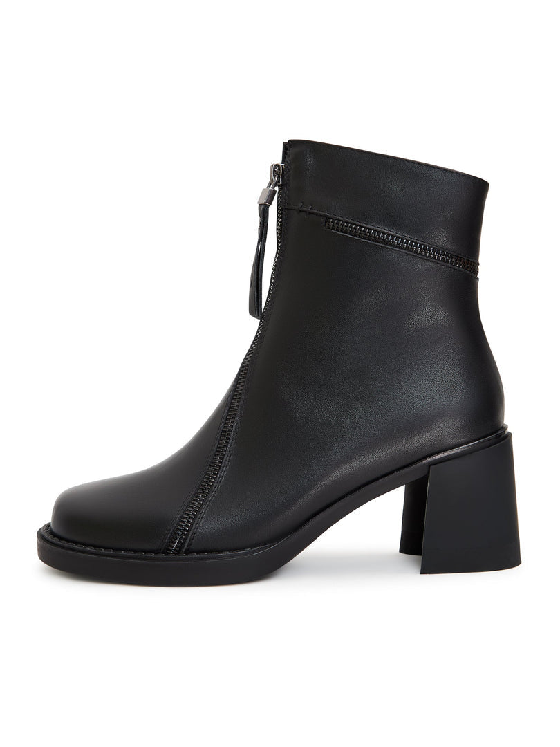 A pair of black block heel ankle boots, classic and chunky heel boots in vintage style with a retro touch.