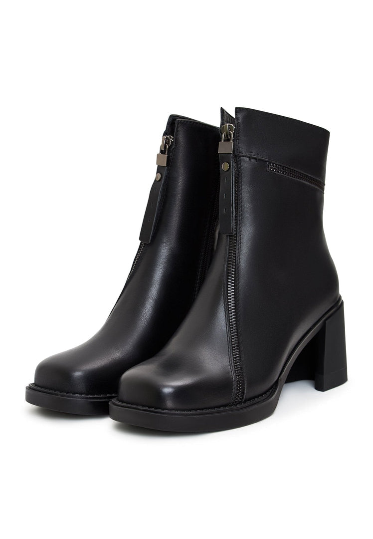 A pair of black block heel ankle boots with a classic and vintage style, featuring chunky heels and a retro vibe.