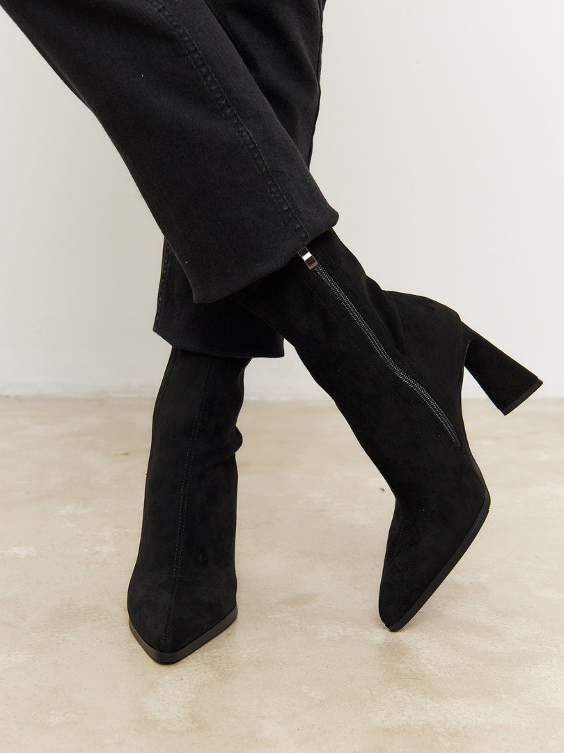 A stylish pair of black suede ankle boots with a trendy block heel, perfect for casual everyday wear.