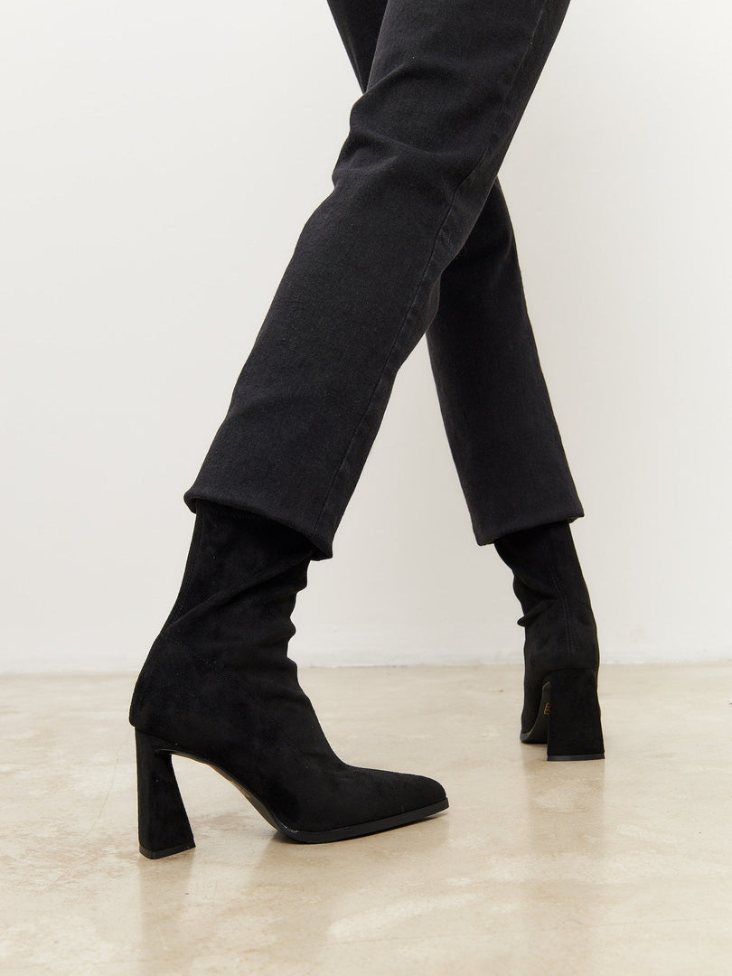 A stylish pair of black suede ankle boots with a chic block heel, perfect for casual wear.