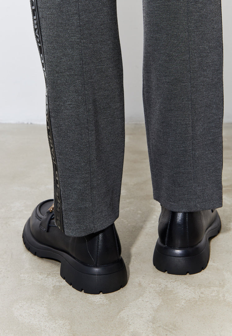 A stylish pair of black leather platform loafers, perfect women's slip-on shoes for a trendy and comfortable look.