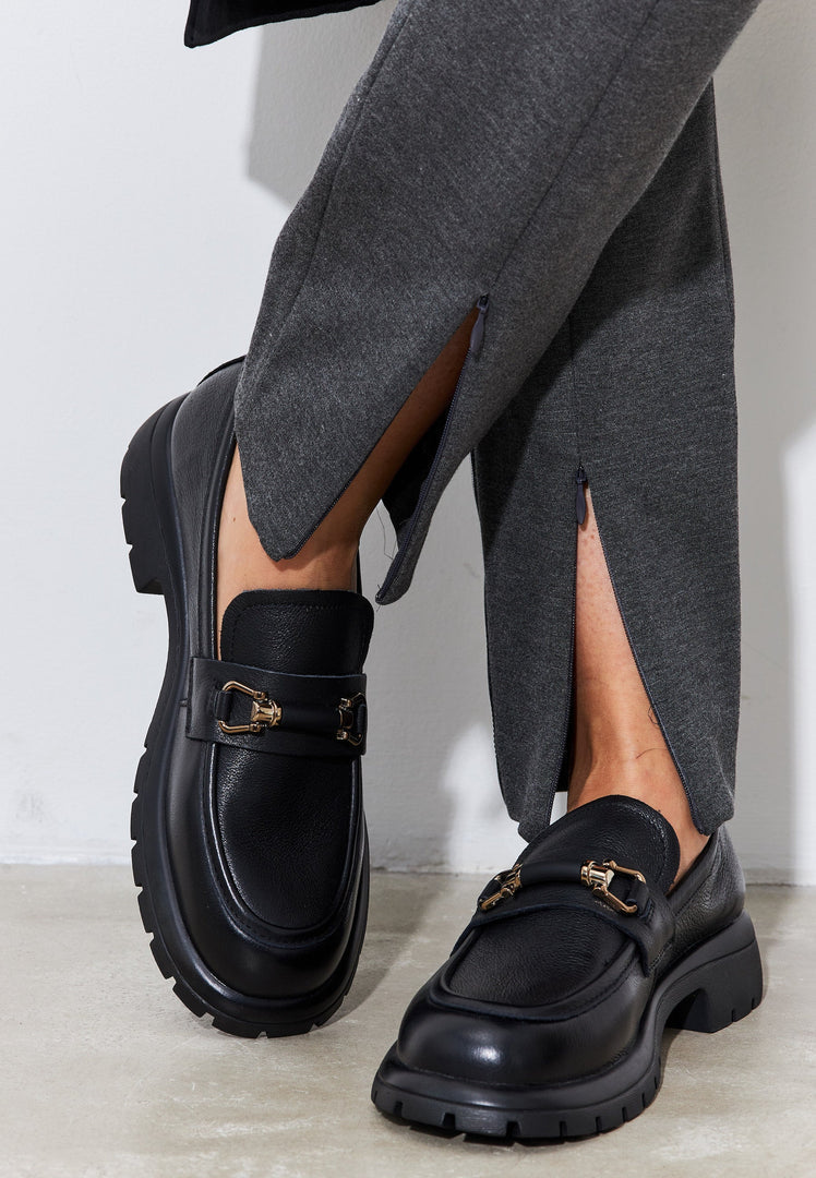 A stylish pair of women's black leather platform loafers, perfect for a chic and comfortable look.