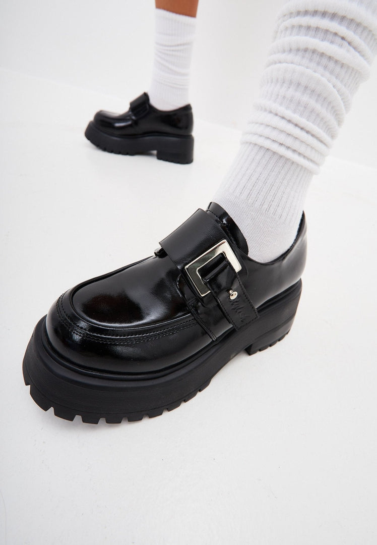 A stylish pair of black leather loafers, perfect for men and women, these comfortable slip-on shoes are a versatile addition to any wardrobe.