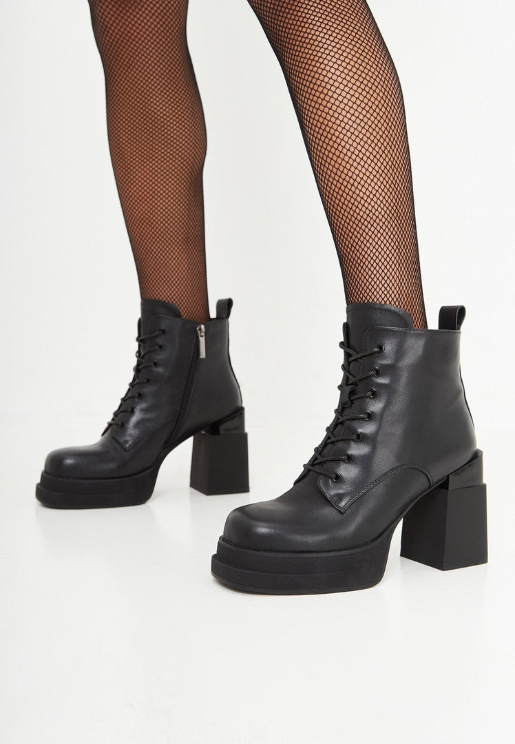 A fashionable pair of leather block heel ankle boots, perfect for adding a stylish touch to any outfit.