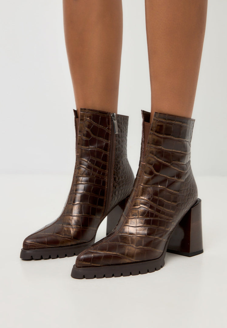 A stylish pair of women's brown Croc block heel boots with a trendy crocodile textured design, known as the Helen brown boots.
