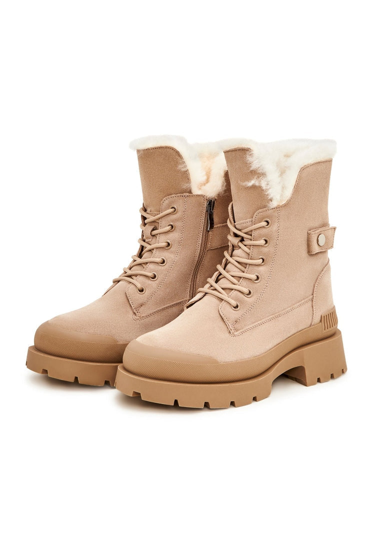 A pair of stylish beige suede ankle boots, the epitome of elegant and fashionable footwear.
