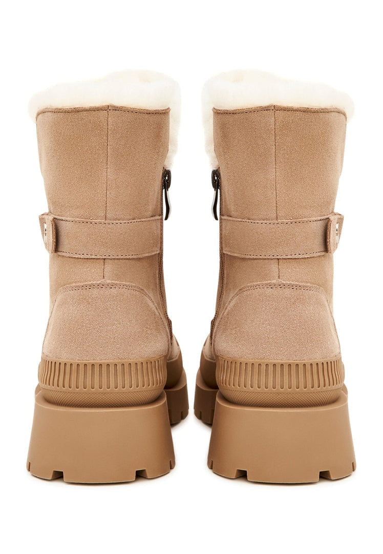 A pair of stylish beige suede ankle boots, the perfect elegant and fashionable footwear choice.