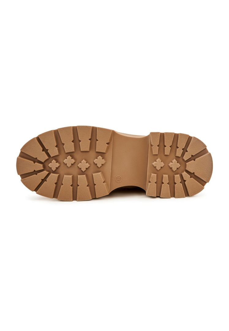 A pair of fashionable beige suede ankle boots, perfect for adding a touch of elegance to any outfit.