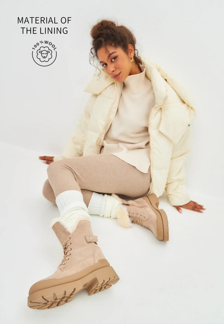 A pair of fashionable beige suede ankle boots, the epitome of elegant and stylish footwear.