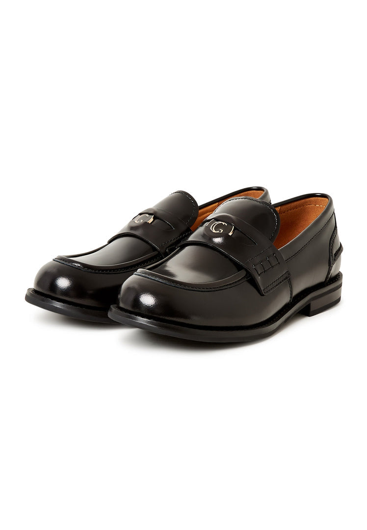 A stylish and comfortable pair of women's black leather block heeled loafers, known as Dinara black shoes, with a chunky heel design.