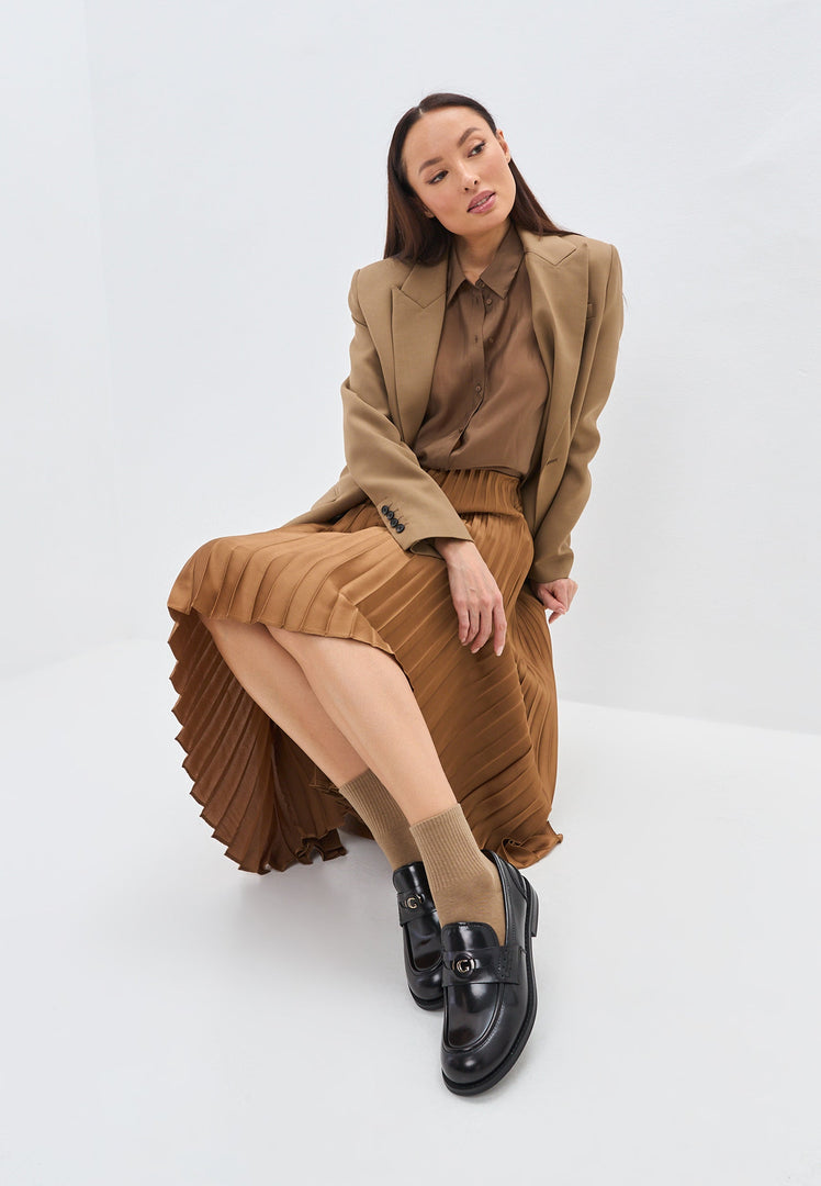 A stylish pair of women's black leather block heeled loafers, also known as Dinara black shoes, featuring a chunky heel design.