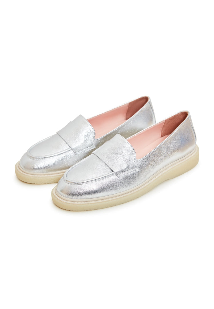 A pair of sleek silver flat sole slip-on loafers for women, the epitome of stylish footwear.
