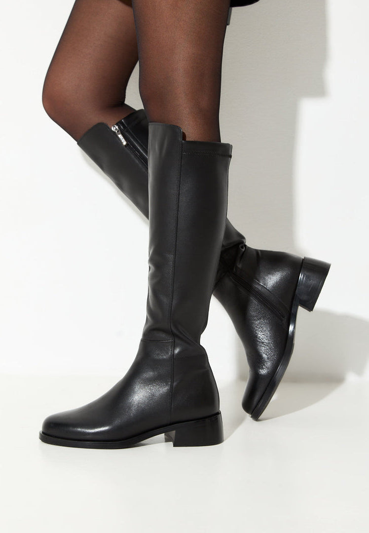 A stylish pair of classic black leather knee-high boots for women, the perfect fashion statement.