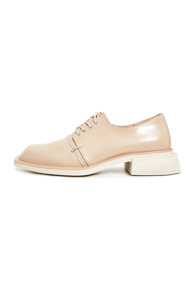 A stylish pair of men's beige leather lace-up loafers, perfect for any occasion.
