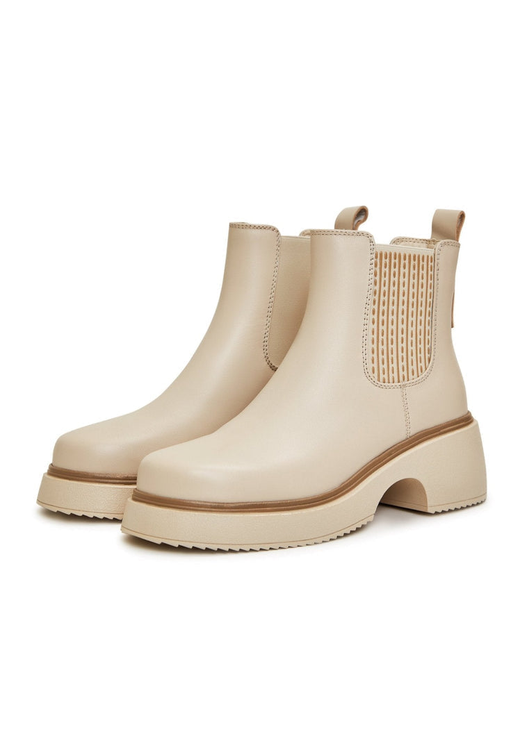 A stylish pair of women's beige leather ankle boots with platform soles, the perfect addition to your fashion footwear collection.