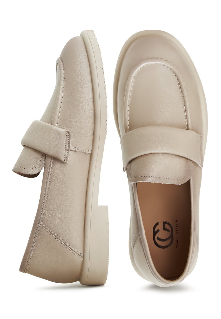 A stylish pair of block-heeled beige Stephanie women's loafers, perfect for adding a touch of fashion-forward sophistication to any outfit.