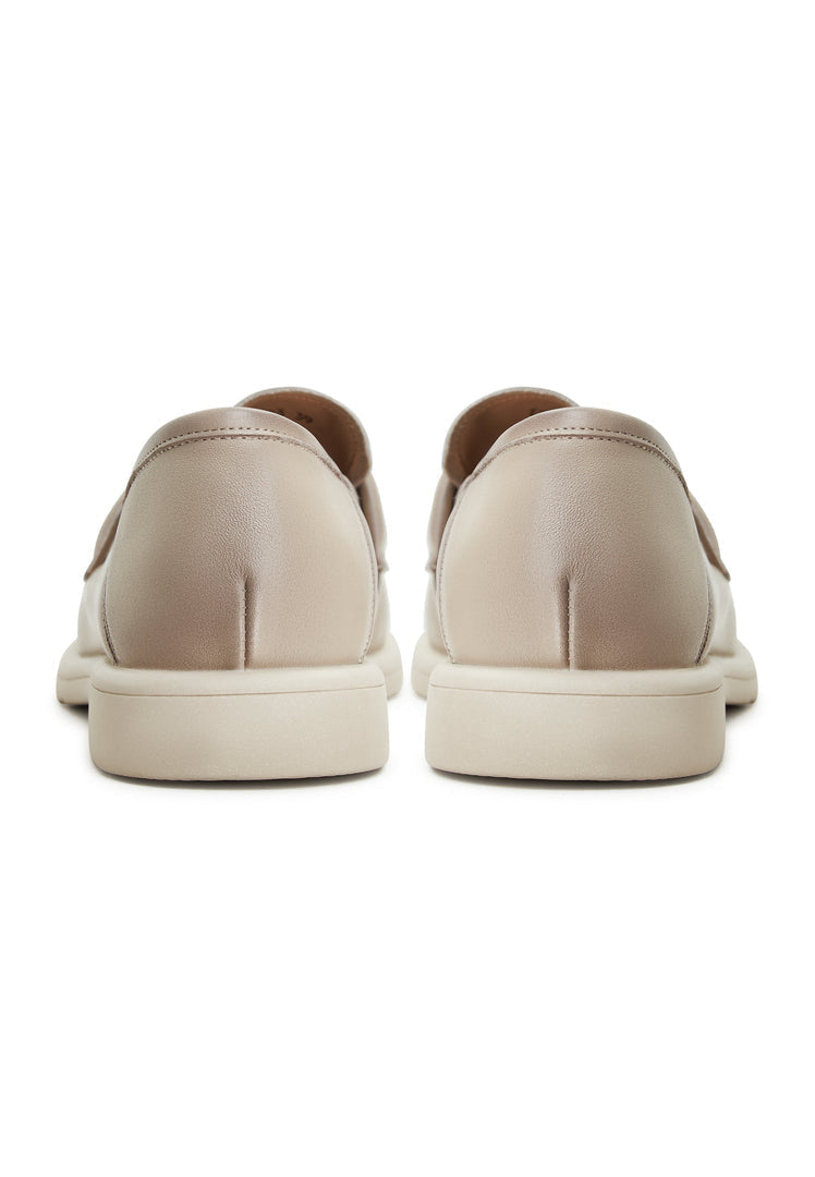 A stylish pair of women's block heeled beige loafers, known as the Stephanie loafers, a fashion essential for any wardrobe.