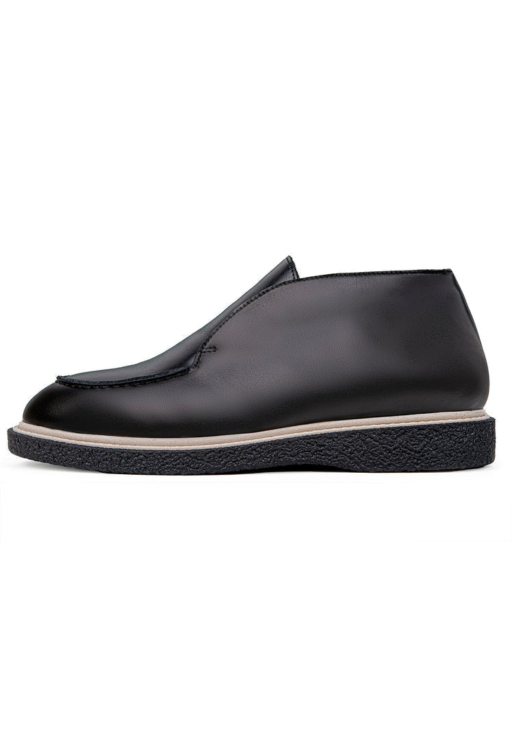 A trendy pair of men's slip-on loafers in classic black, perfect for a fashionable and effortless style statement.