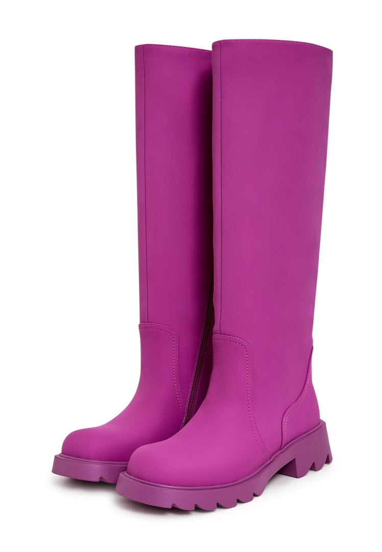 A stylish pair of trendy knee-high chunky sole pink boots, perfect for women's fashion footwear.