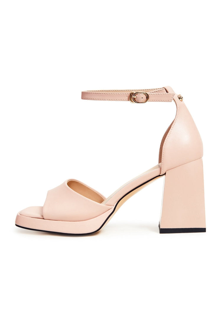 A pair of elegant beige open toe high heel sandals, the perfect choice for a classic and timeless look.