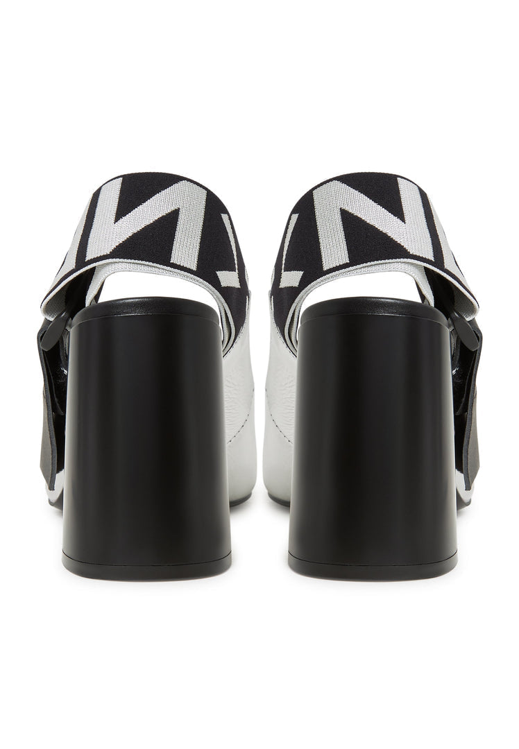 A stylish pair of silver Block heeled pumps and Slingback heels known as Jimena pumps, perfect for any fashionable woman's footwear collection.