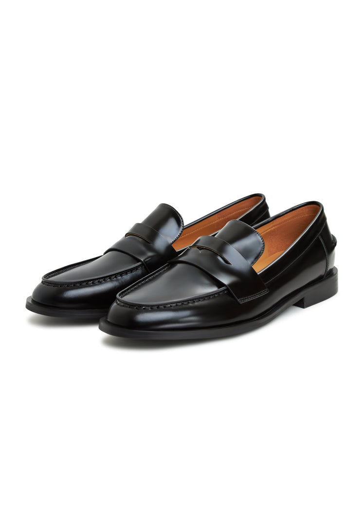 A stylish pair of black patent leather block heeled loafers for women, featuring a sleek and sophisticated design.