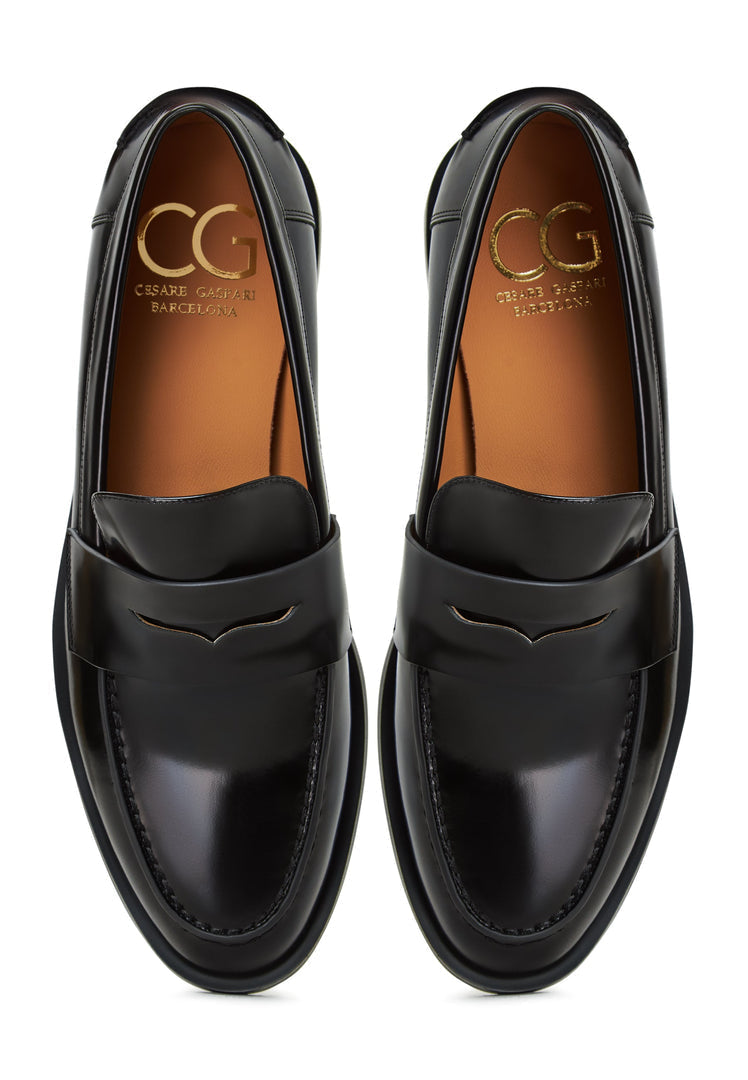 A stylish pair of patent black leather block heels, perfect for women who love a chic and versatile option like block heeled loafers.