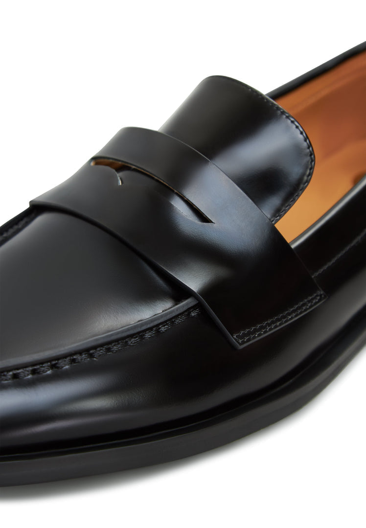 A stylish pair of women's black patent leather loafers with block heels.