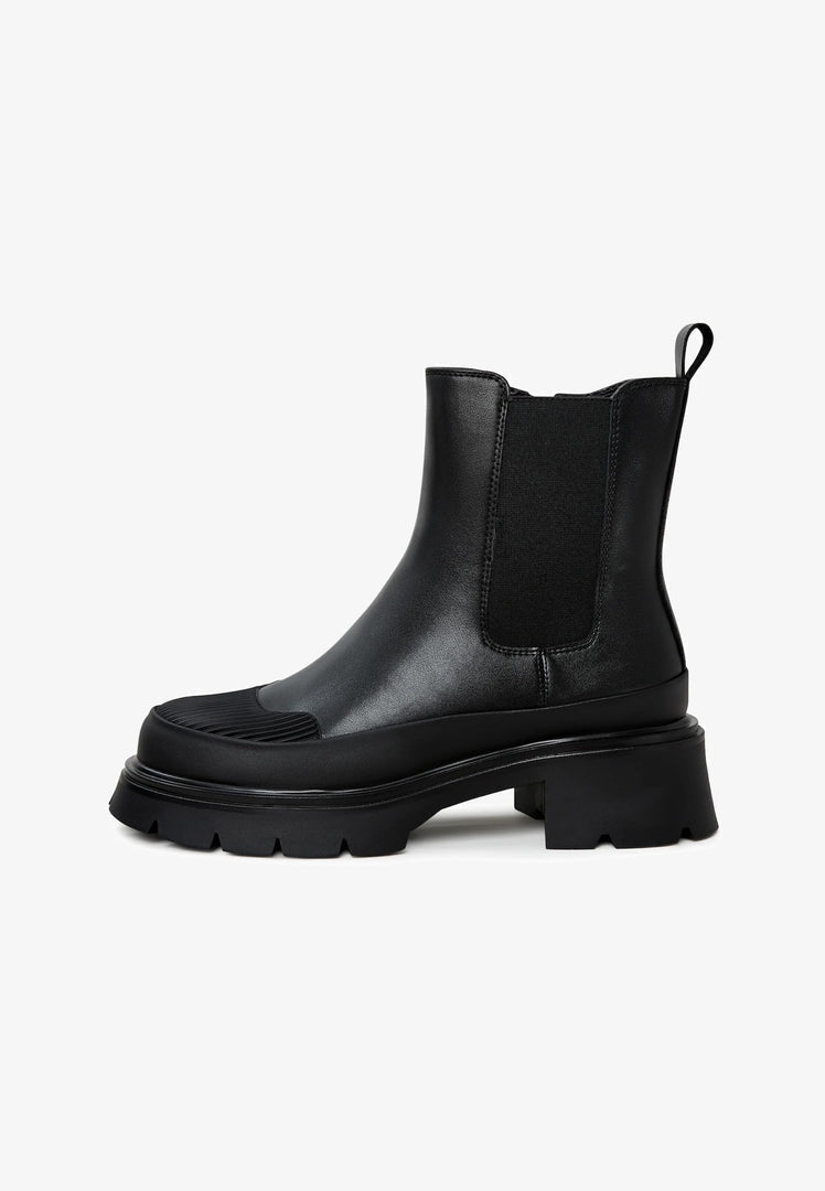 A stylish pair of black urban ankle boots with a platform design, perfect for women's fashion footwear.