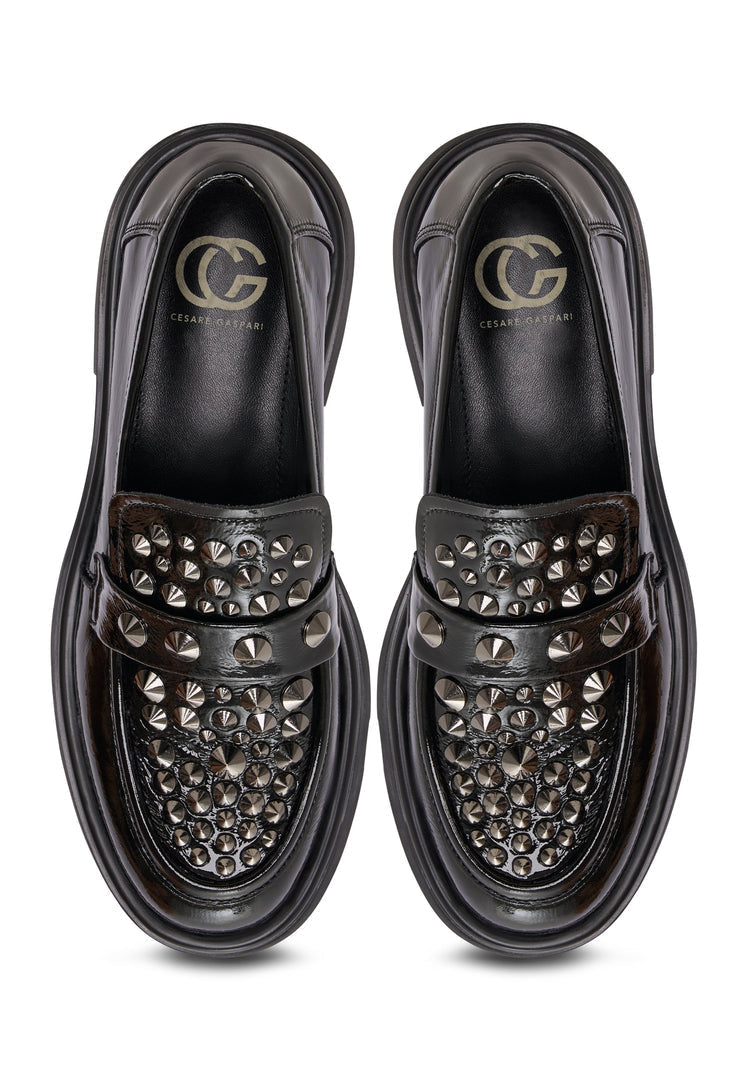 A pair of black leather loafers inspired by rockstar fashion, the perfect addition to men's stylish footwear.