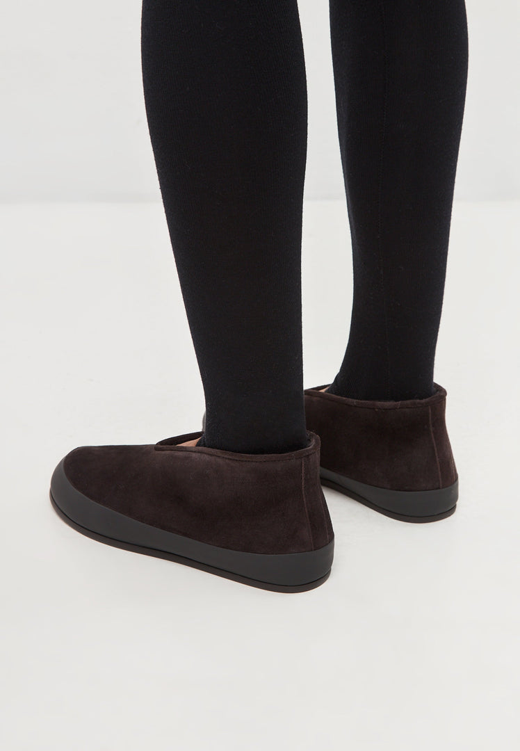 A pair of stylish brown leather slip-on Amara winter boots for women to keep your feet warm and trendy during the cold season.